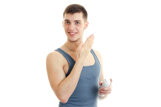 young handsome guy holding a shaving foam and smiling photo