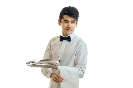 young dark haired waiter holding a tray with a towel and looking toward photo