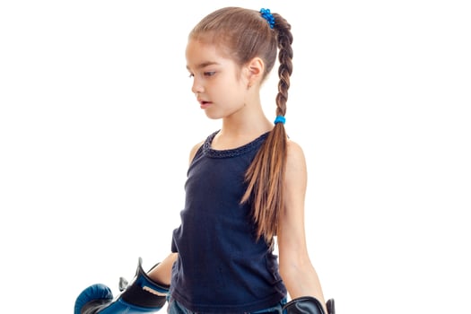 young girl in boxing gloves practicing photo
