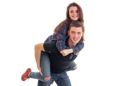joyful young girl on shoulders by the beautiful fun guy photo