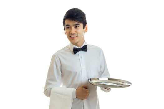perky young waiter looks to the side and holding a blank tray for eating photo