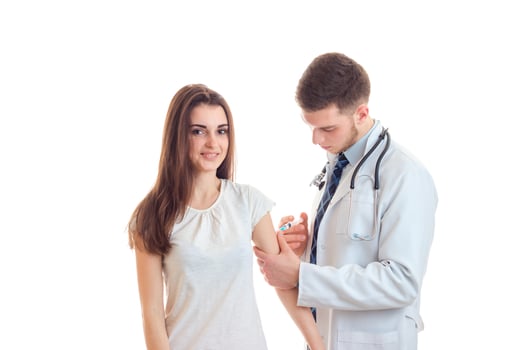 young cute girl is smiling and the doctor makes her hand tuck photo