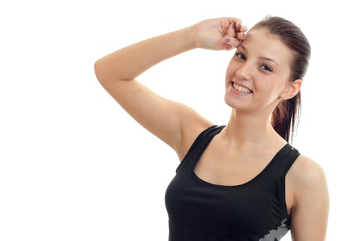 horizontal portrait of young sports girl who smiles and holds his hand near the face photo