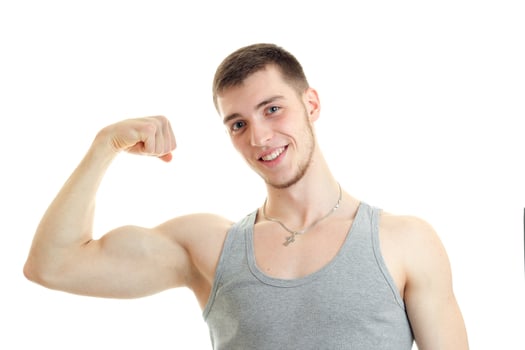 horizontal portrait of beautiful sports guy who smiles and shows his muscle on hand photo
