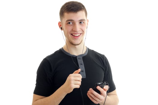 close-up portrait of a handsome guy who smiles and holds phone photo