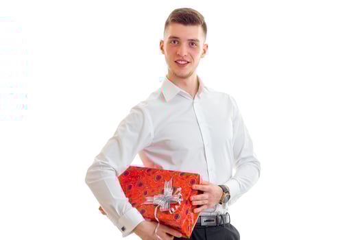 elegant guy in a white shirt and a large red gift in the hands photo