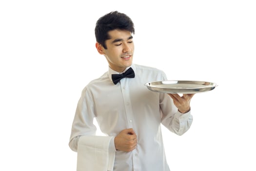 young charming waiter raised his hand empty tray for eating and smiling photo