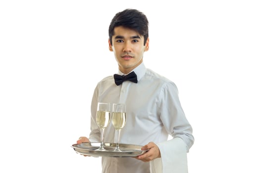 amazing beautiful waiter holding a tray with glasses of wine isolated on a white background photo