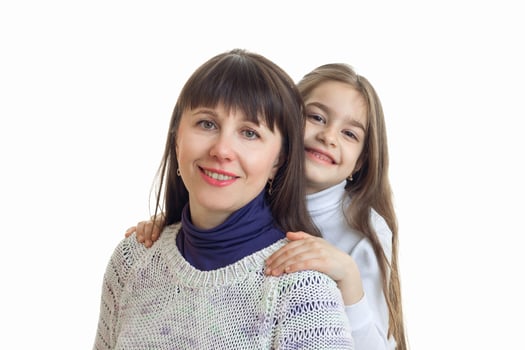 daughter hugs her mother and smiling into the camera photo