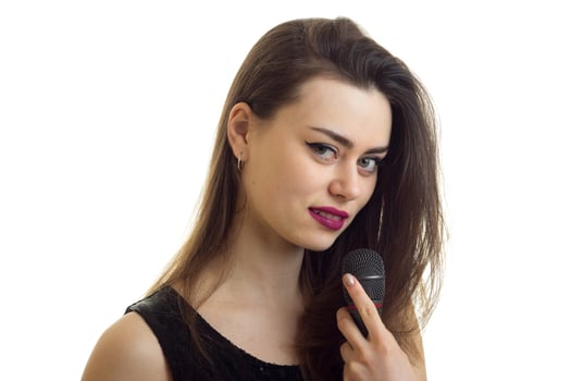 Close up portrait of beautiful young girl with make up and microphone in hands photo