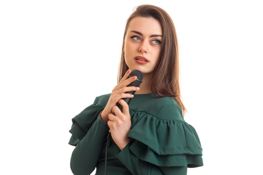 charming woman in green color dress with microphone photo