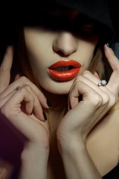 close up portrait of girl with healthy skin and red lips with her eyes in shadow photo
