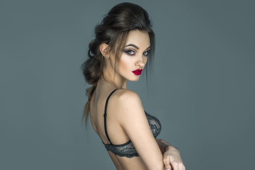glamour girl with beautiful hairstyle and make up looking at the camera in lace bra photo