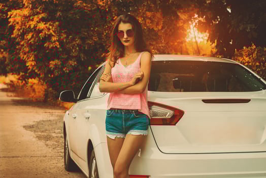 cute young lady stands at the sunset photo