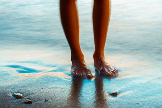 legs at the sea in the evening photo