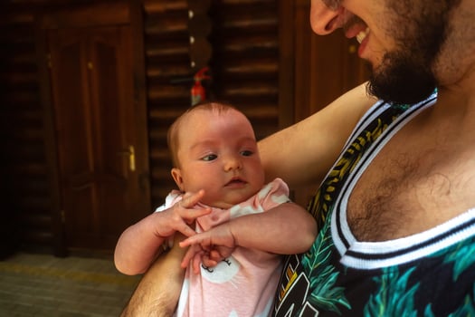 Cute little baby in Daddy's arms photo