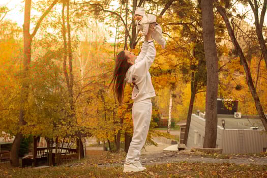 beautiful young mom with baby in autumn photo