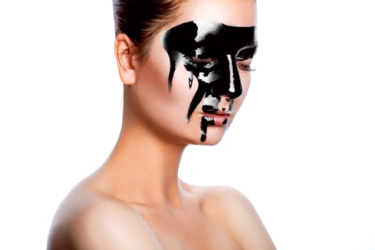 Horizontal photo of beauty woman with black paint on face