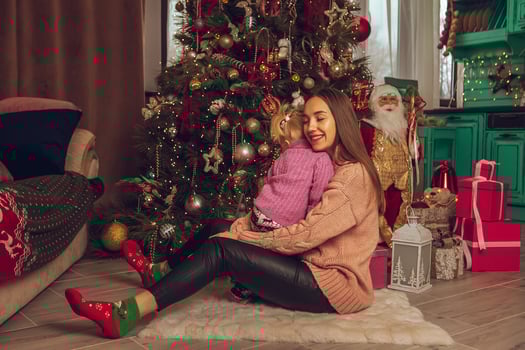 Lovely young mother with little baby girl celebrate Christmas photo
