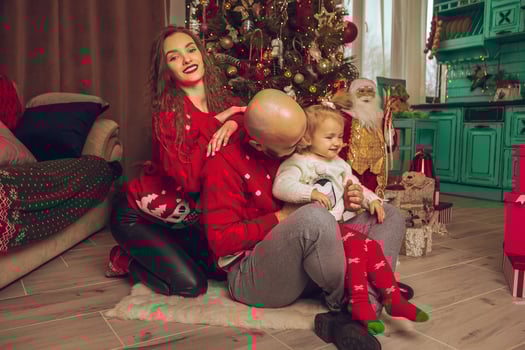Happy young family with daughter celebrate Christmas and New year together photo