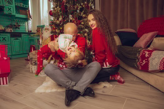 horizontal photo of funny family with daughter celebrate New year and Christmas together at home