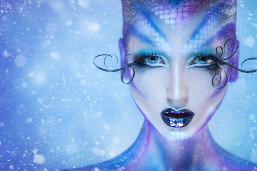 Gorgeous fashion portrait of beauty young adult girl with creative body art and snow on background photo