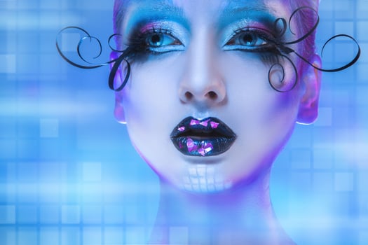 Wonderful portrait of beauty model looking away on blue background with creative face art photo