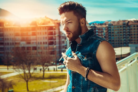 Horizontal photo of sexy male fashion model with cigarette