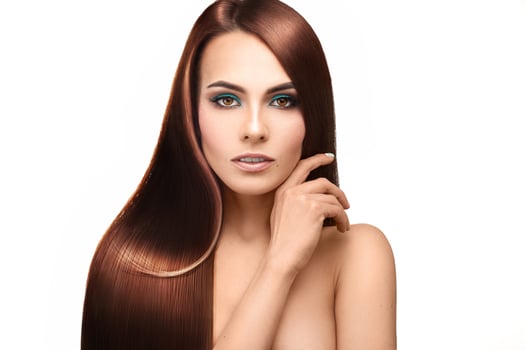 Beautiful lady with perfect straight hair looking at camera on white background photo