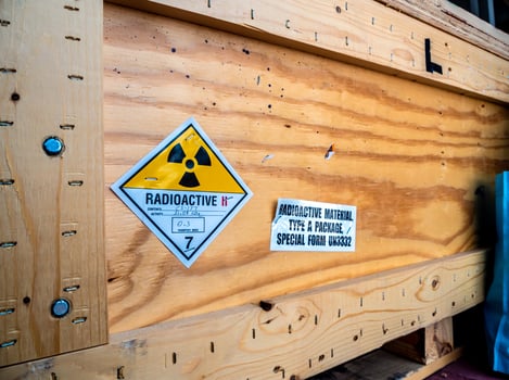 Radiation label beside the transport wooden box Type A package photo