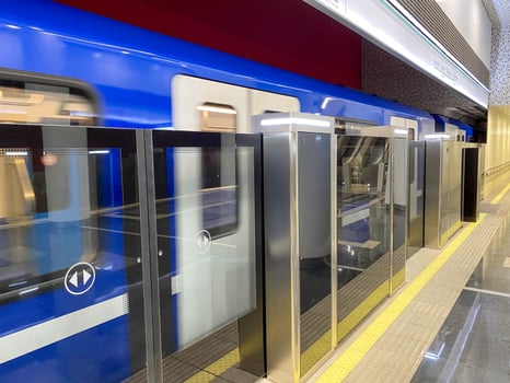 Detailed view of closed, sliding doors seen on a commuter train, located at the station platform. This carriage allows bicycles to be taken during transit photo
