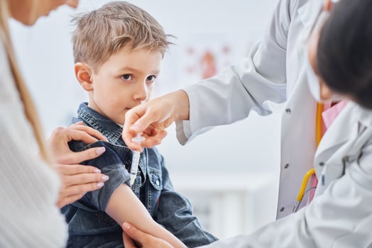 Little boy being vaccinated by pediatrician photo