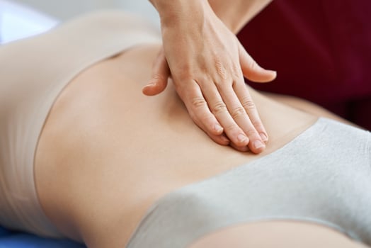 Physiotherapist in mask helping female patient photo