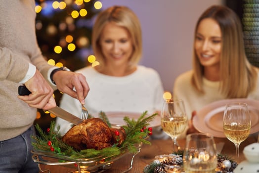 Friends celebrating christmas party holding wine photo