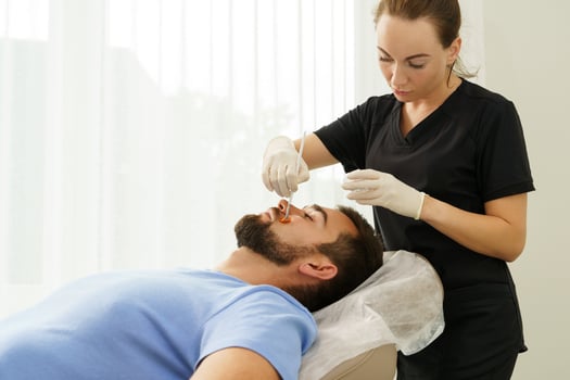 Young man during peeling treatment in beauty clinic photo