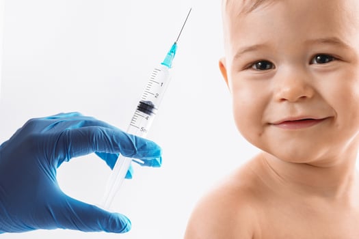 Brave smiling little boy is ready for a vaccine photo