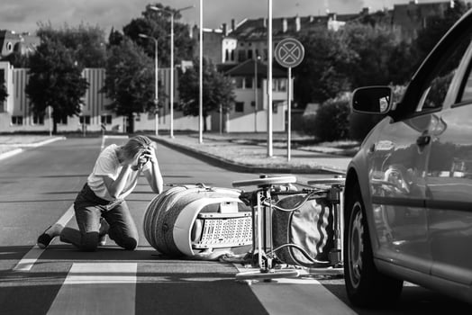 Shocked mother on the crosswalk after a car accident when a vehicle hits her baby pram. photo