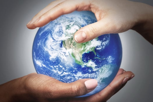 African and Caucasian female hands holding earth globe. Elements of this image furnished by NASA. photo