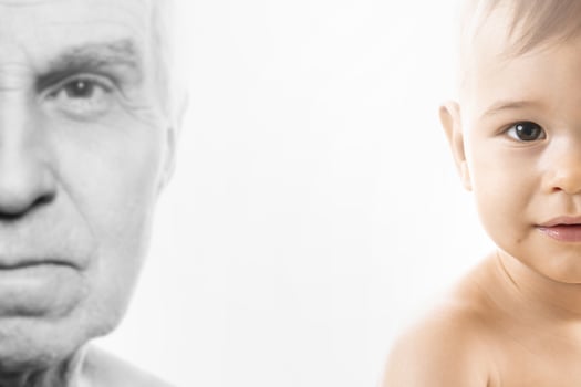 Elderly man and baby boy. Concept of rebirth and cycle of life. photo