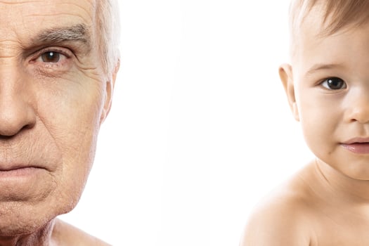 Elderly man and baby boy. Concept of rebirth and cycle of life. photo