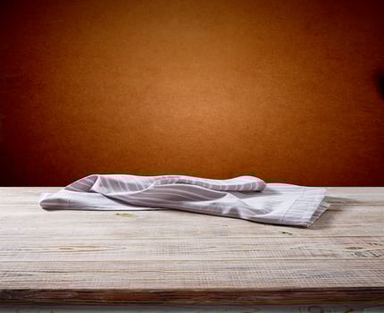 White napkin, table cloth on wooden deck mockup. photo