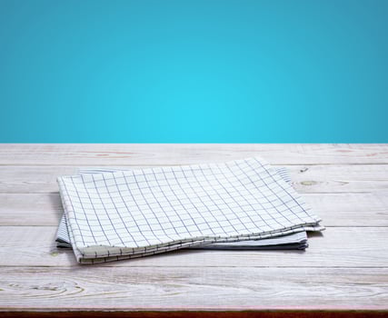 Kitchen towel, napkin on wooden desk. Top view mockup photo