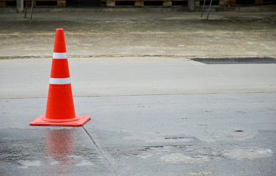 orange traffic cone set on the road photo