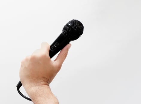 Man with microphone on white background photo