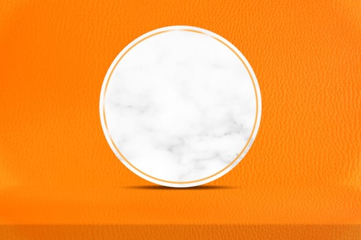 Orange Leather Table and Circle Marble Partition with Wall Texture Background, Suitable for Cosmetic Product Presentation Backdrop, Halloween Display, and Mock up. photo