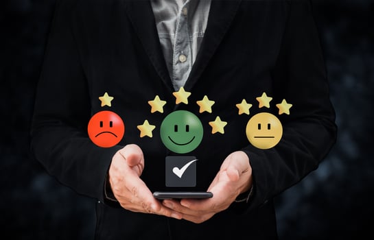 person hand using smartphone give happy smile icon and five star symbol to increase rating of product and service concept, Customer service experience and business satisfaction survey. photo