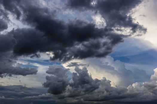 The dark sky with heavy clouds converging and a violent storm before the rain.Bad or moody weather sky and environment. carbon dioxide emissions, greenhouse effect, global warming, climate change. photo