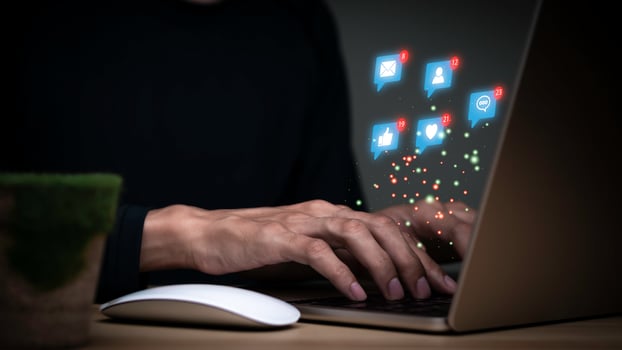 Concept with notification icons of like being happy.and social media interactions on laptop,message, email, comment ,businessman hands holding device,smartphone, internet digital marketing. photo