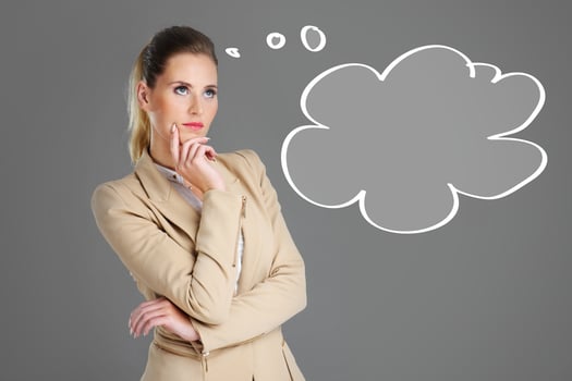 Businesswoman thinking over grey background photo