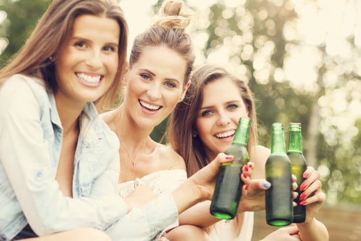 Happy group of friends drinking beer outdoors photo